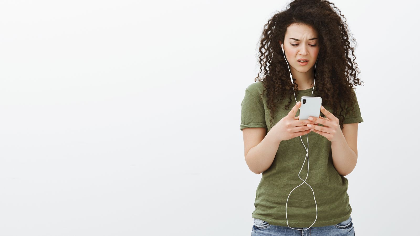 mulher de cabelo cacheado estressada por ouvir audio