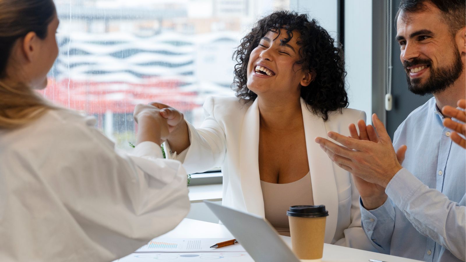Mulher extrovertida cumprimentando entrevistadora