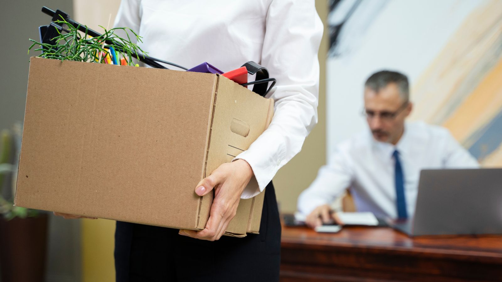 Homem carregando caixa após demissão